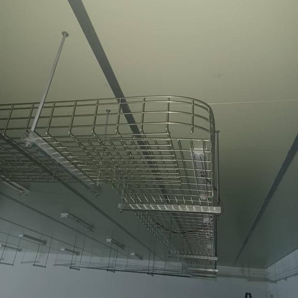 Cable basket tray installed along a factory ceiling