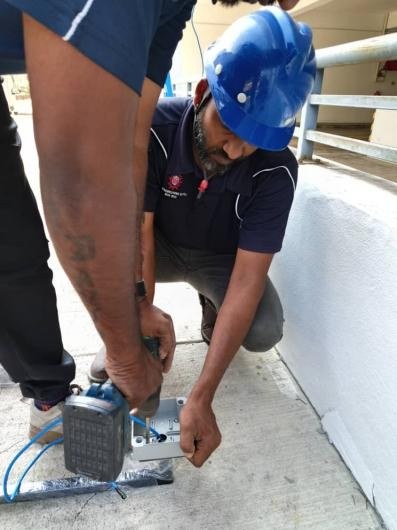 Installer fixing a camera bracket
