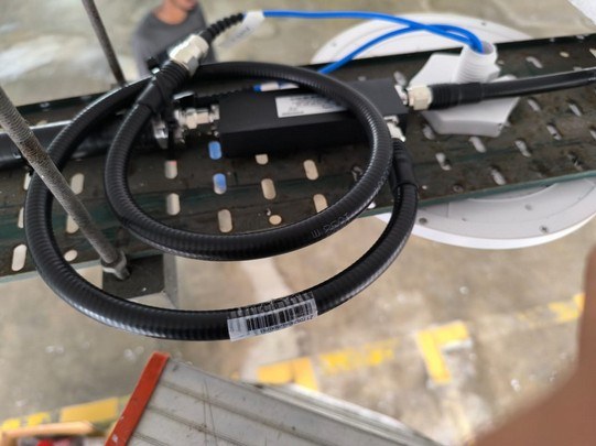 Feeder cable coil on a cable tray for in-building coverage